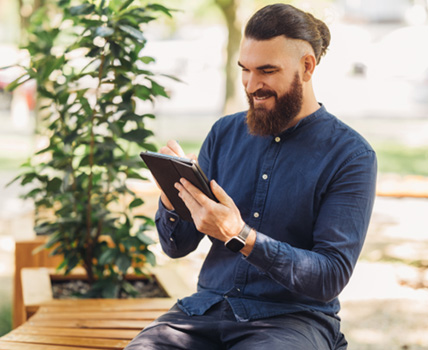 Man using tablet outdoors