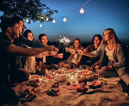 People celebrating with sparklers at night 