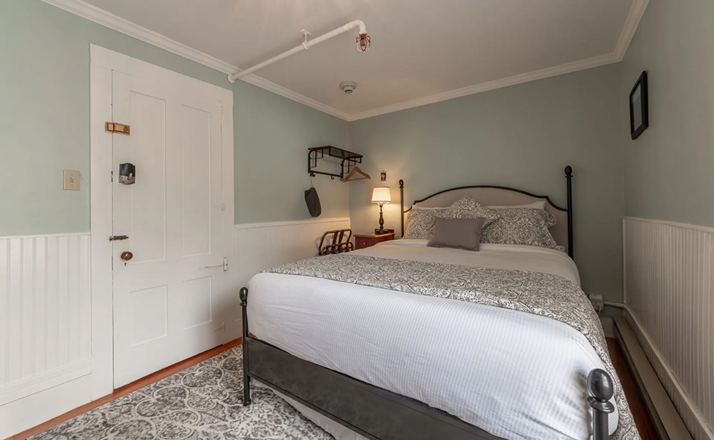 White door near the foot of the bed