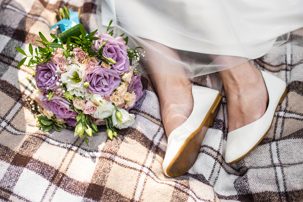 bride relaxing on bed with flowers 